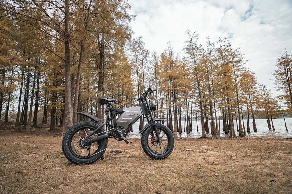 ROGUWEX X5S rugged fat-tire e-bike parked by a lakeside forest.