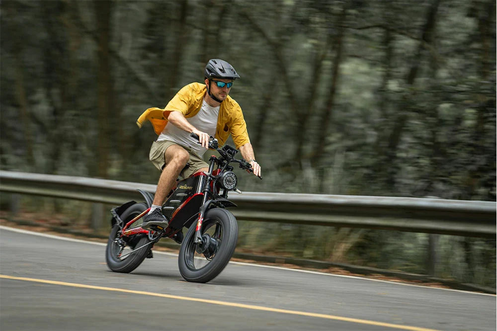 RZOGUWEX X7 rugged e-bike being ridden by a helmeted man on a sun-dappled forest path